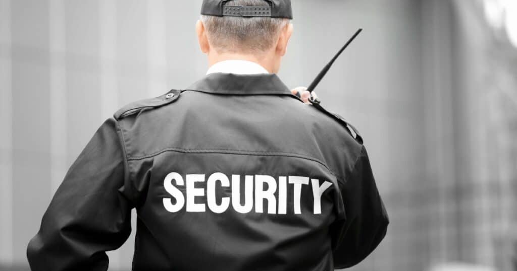 Security guard in uniform with "SECURITY" on back at Nashville event.