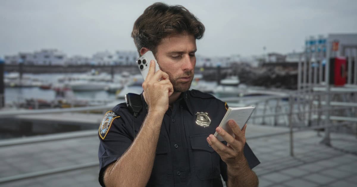 Security officer on patrol using phone at marina in Nashville.
