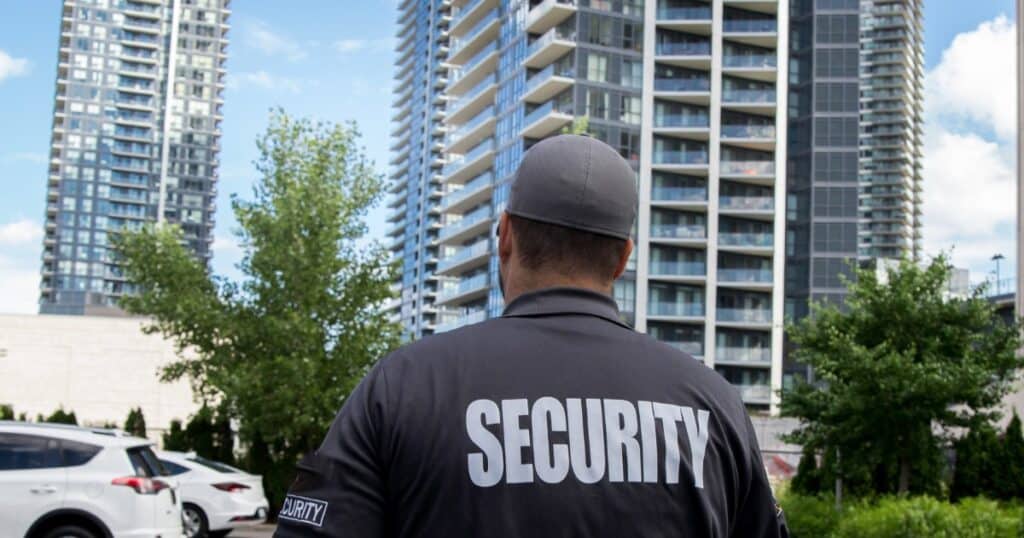 Security guard patrolling urban residential area for safety and crime prevention.