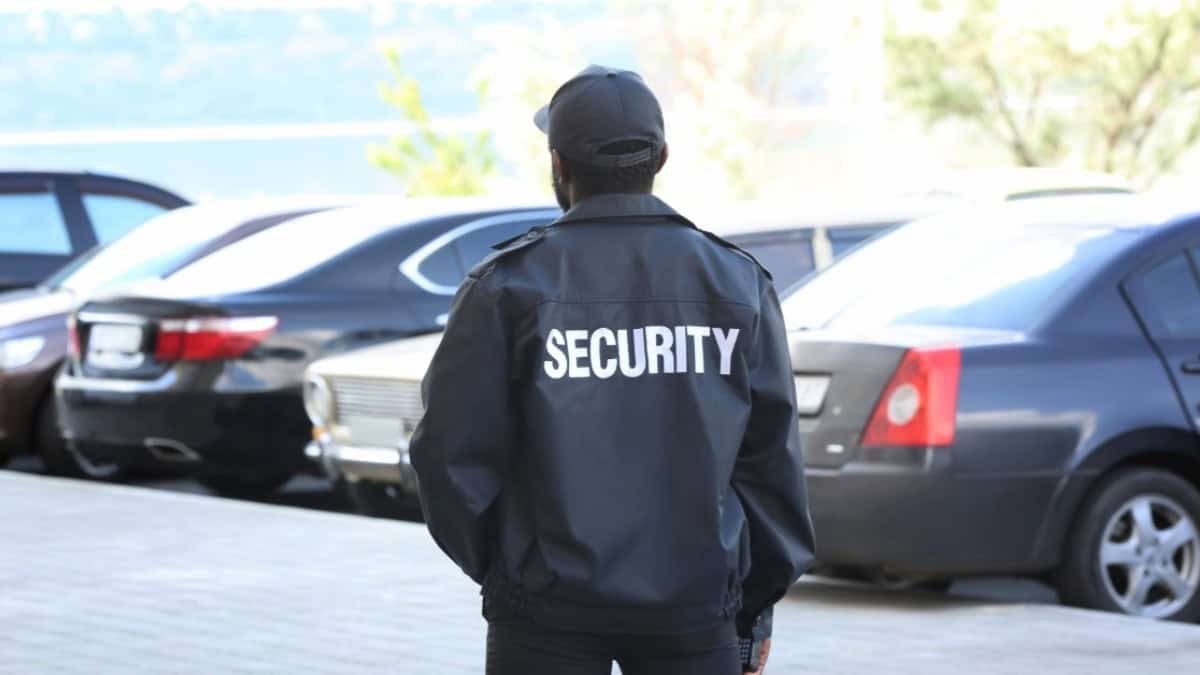 Security guard monitoring parking lot for safety and security.